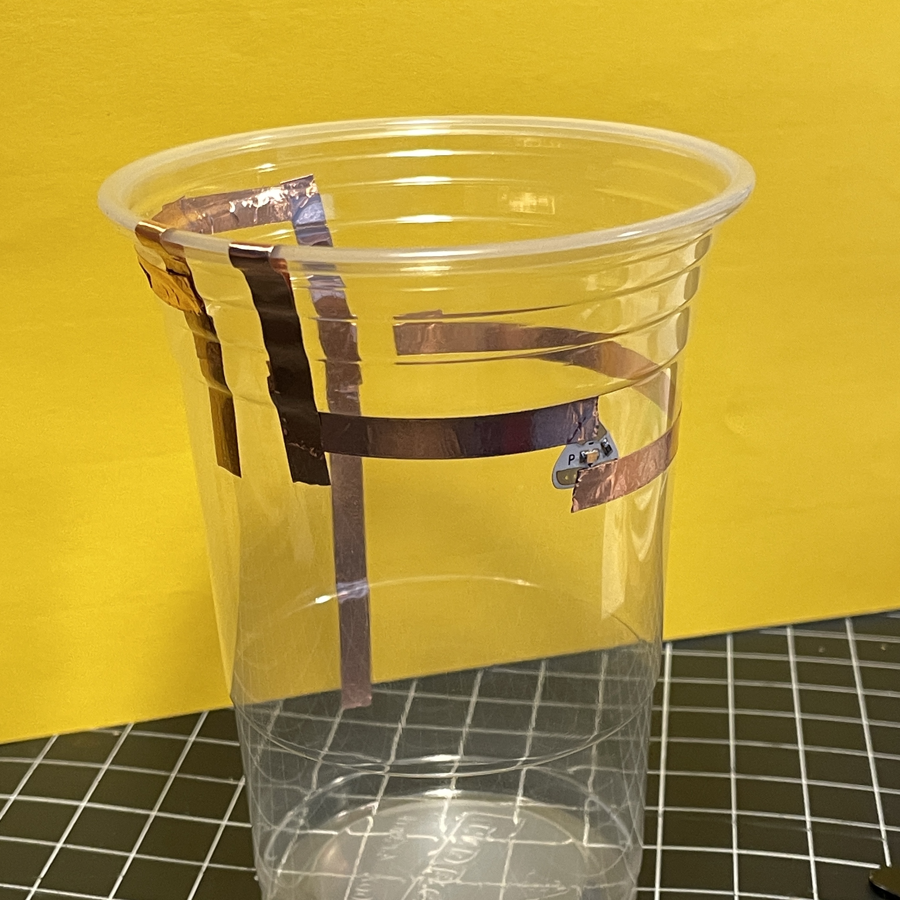 For this I had the idea to use water as a conductive material. There is a break in the circuit that is completed when the water is high enough in the cup, turning on the light. 
    I lined up the light (as best I can) to the height of the water so that you know when the cup is full and at what level the water is.<a href='https://youtu.be/2l4Lxetv9VY' target='_blank'><p>Cup Video</p></a>